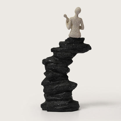Guitarist Figurine on Stacked Rock Sculpture